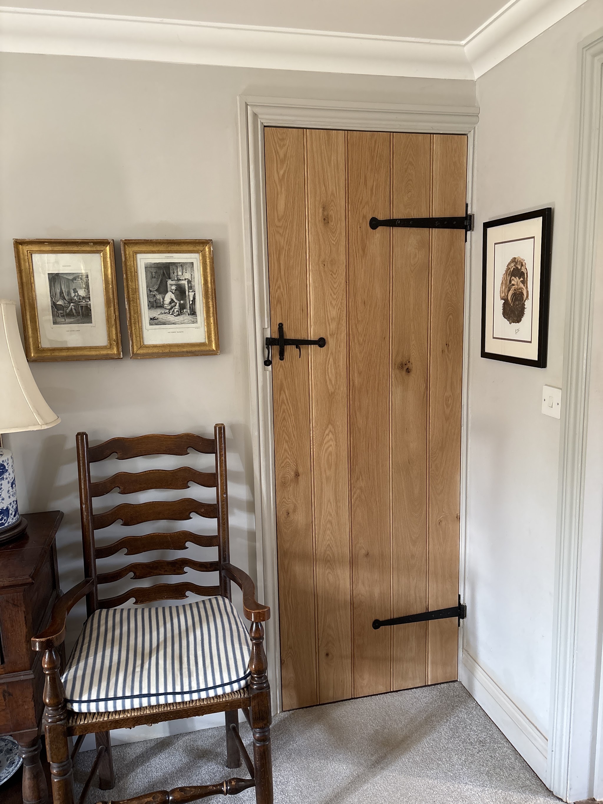 Traditional oak ledged and braced door with black iron hinges and latch