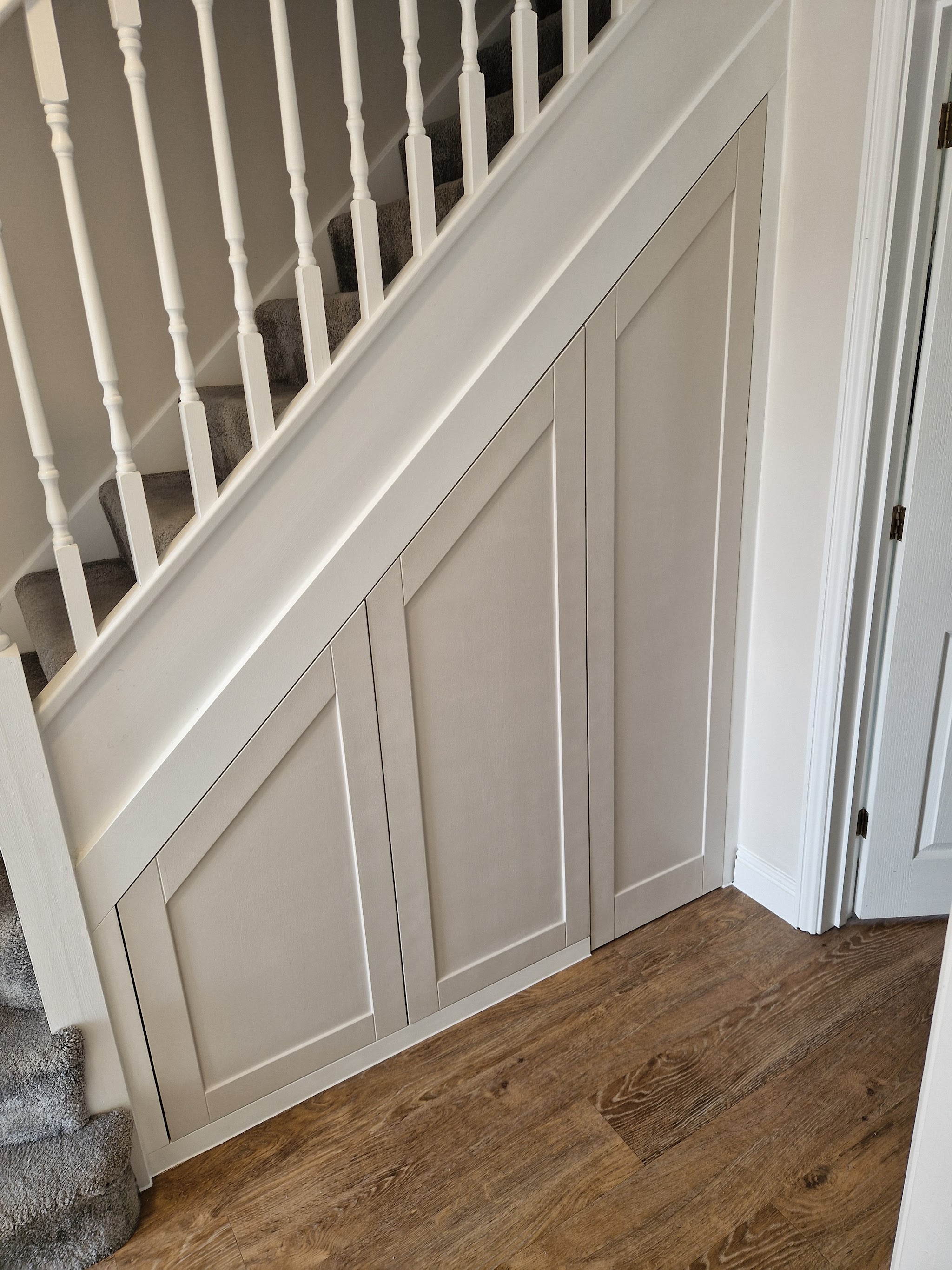 White panelled understairs cupboard doors