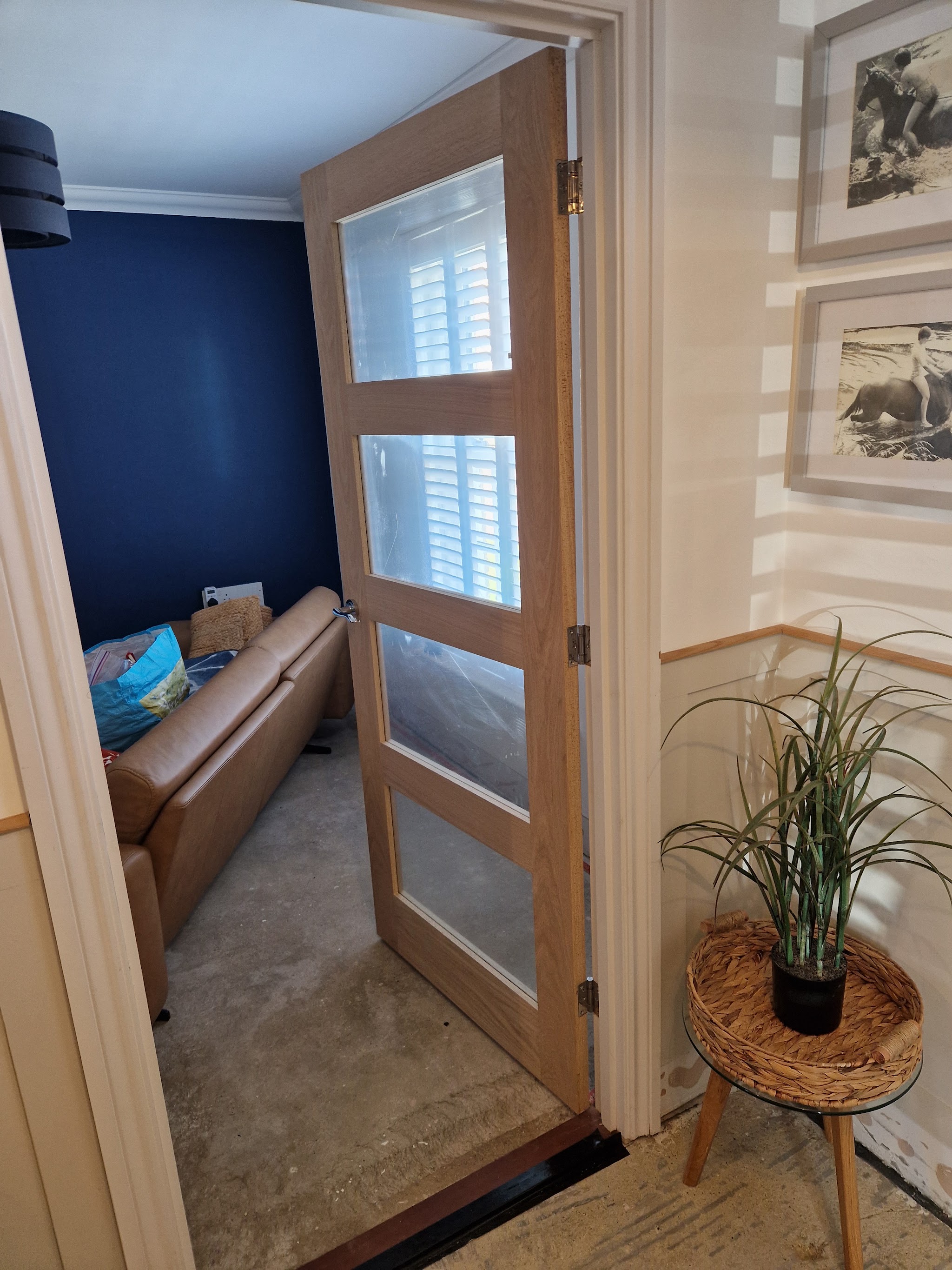 Glazed oak internal door fitted in a hallway